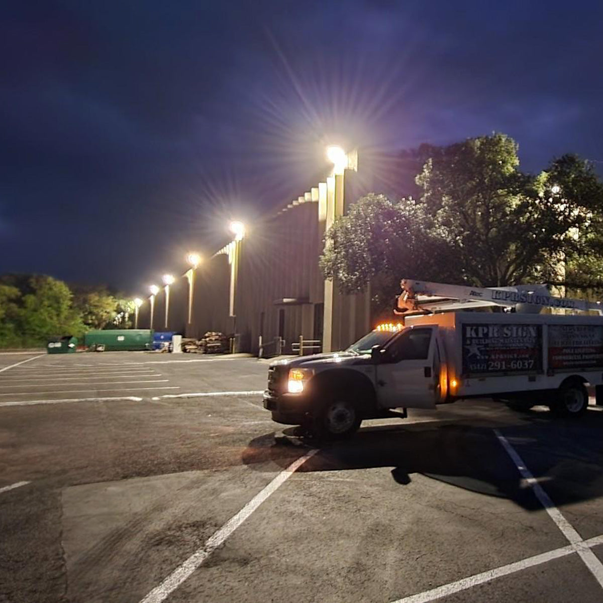 LUX LED Flood Light illuminating a parking lot with bright, efficient commercial-grade outdoor lighting at night.