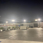 LUX LED Flood Light illuminating a large outdoor parking lot for bright and efficient nighttime visibility
